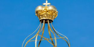 Peak of the roof with a golden crown at Bruchsal Palace.